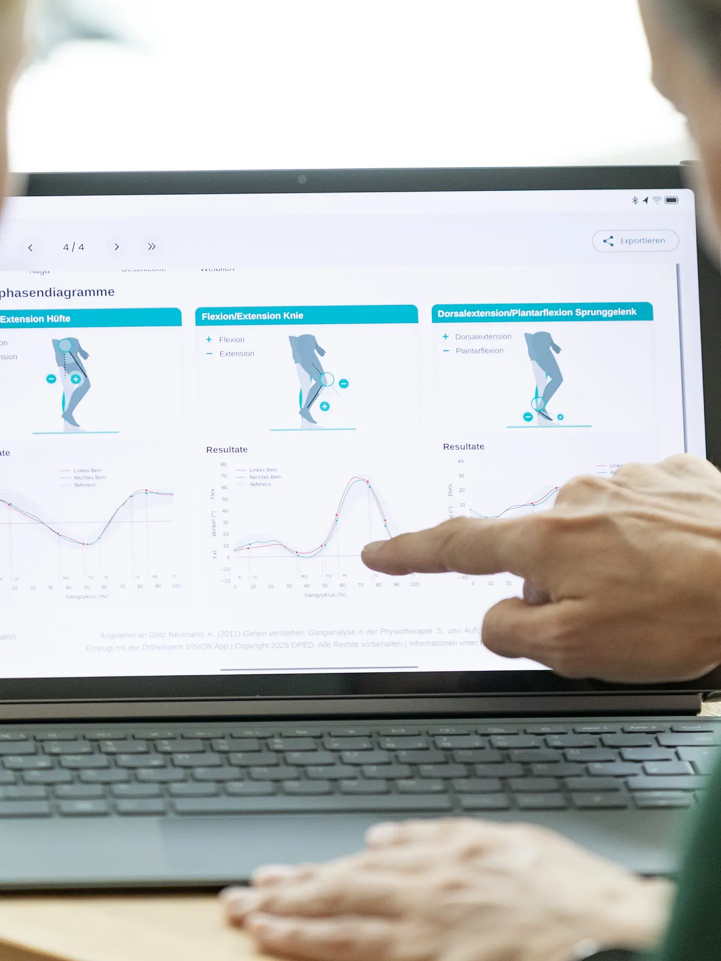 Therapeut analysiert den Laufstil einer Probandin am Laptop im Park Igls