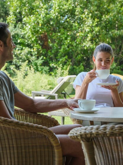 Couple drinking tea in the garden 